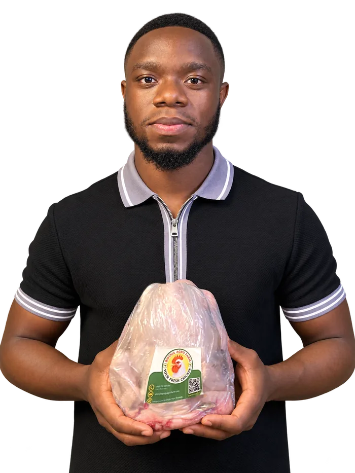 Bwinja Agro Farm team member holding a freshly packaged, labeled chicken